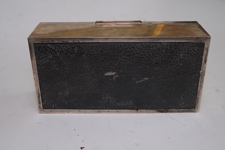 An Elizabeth II silver mounted rectangular cigarette box, by Garrard & Co, Birmingham, 1957, with engraved crest and motto, 18cm. Condition - poor to fair